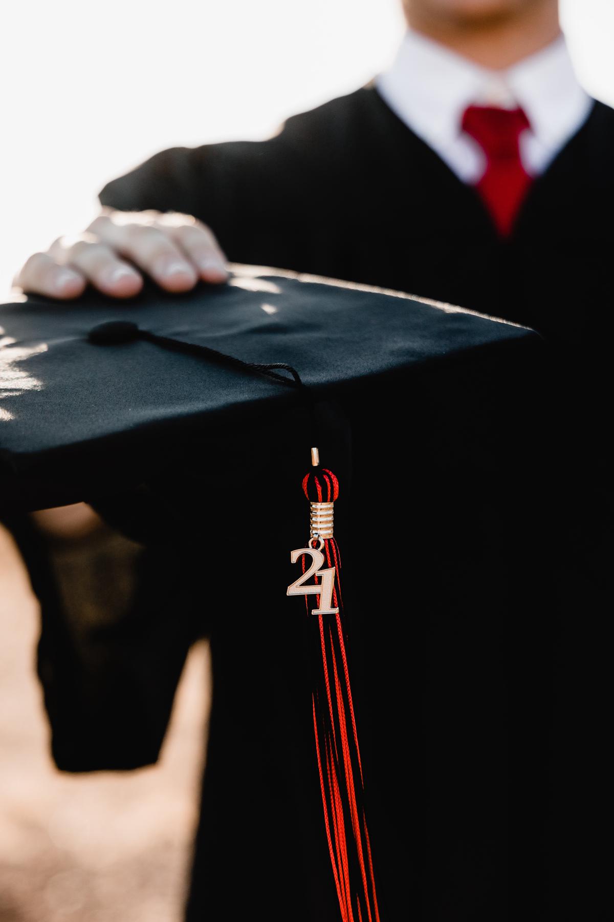a person holding a graduation hat